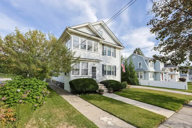 a front view of a house with a garden