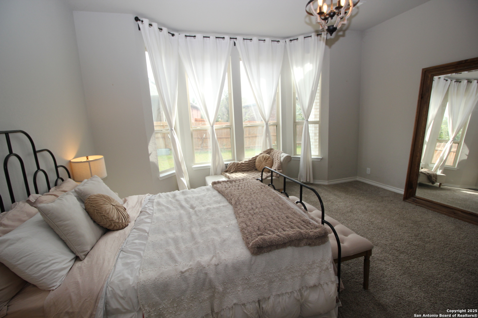 12228 Buckaroo Ranch San Antonio, TX 78254 - Photo 12 of 43 a bedroom with a bed and a large window