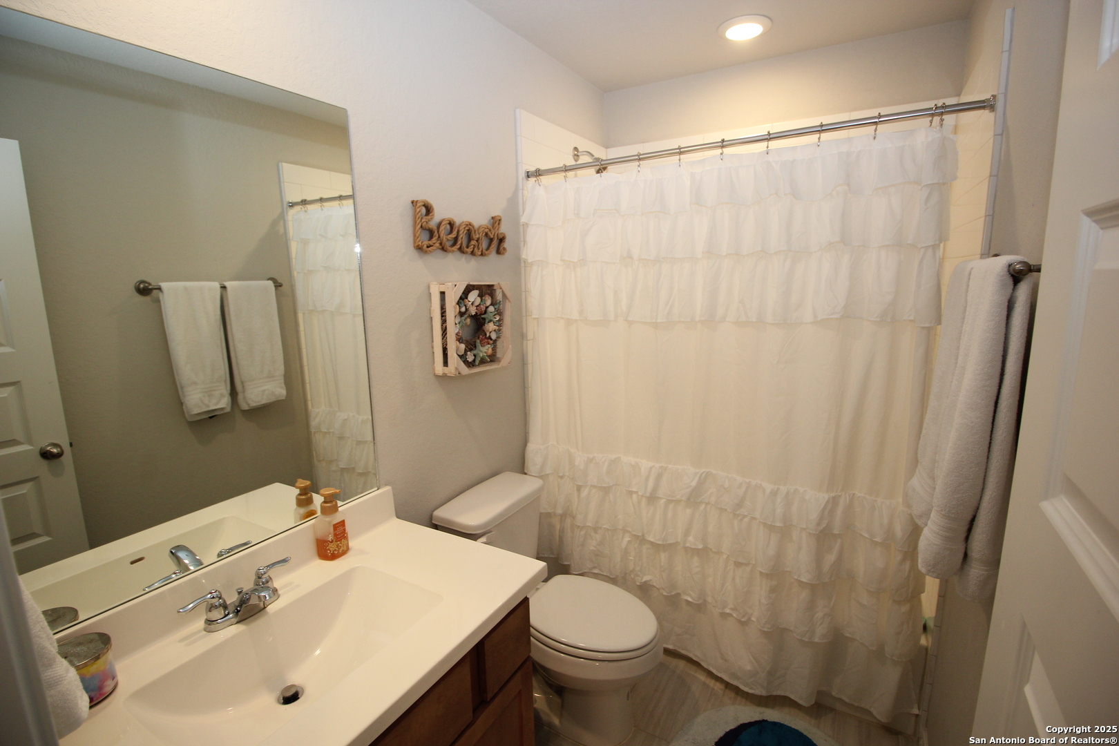 12228 Buckaroo Ranch San Antonio, TX 78254 - Photo 25 of 43 a bathroom with a sink toilet and shower