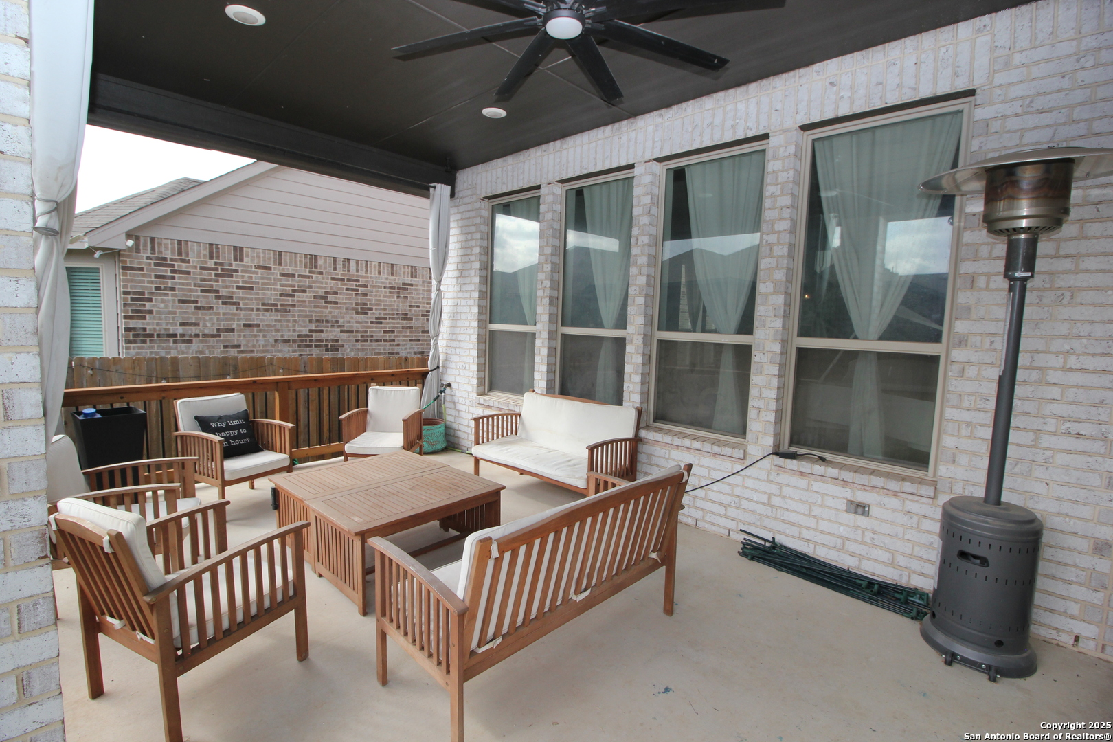 12228 Buckaroo Ranch San Antonio, TX 78254 - Photo 41 of 43 a outdoor space with patio the couches and a fireplace
