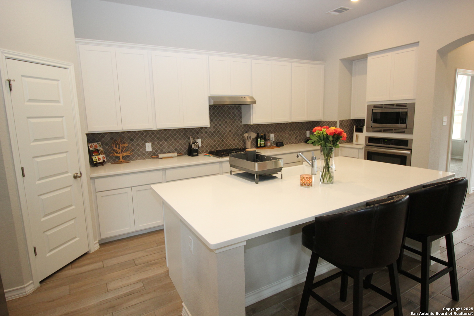 12228 Buckaroo Ranch San Antonio, TX 78254 - Photo 8 of 43 a kitchen with a sink cabinets and white appliances