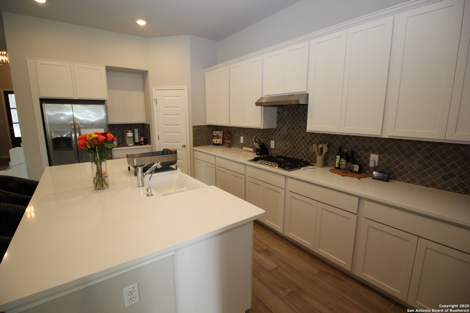 12228 Buckaroo Ranch San Antonio, TX 78254 - Photo 9 of 43 a kitchen with a sink a stove and cabinets