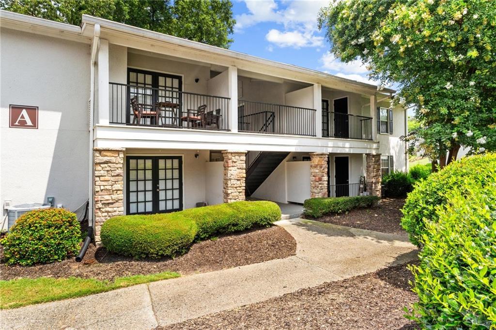 a front view of a house with garden and plants