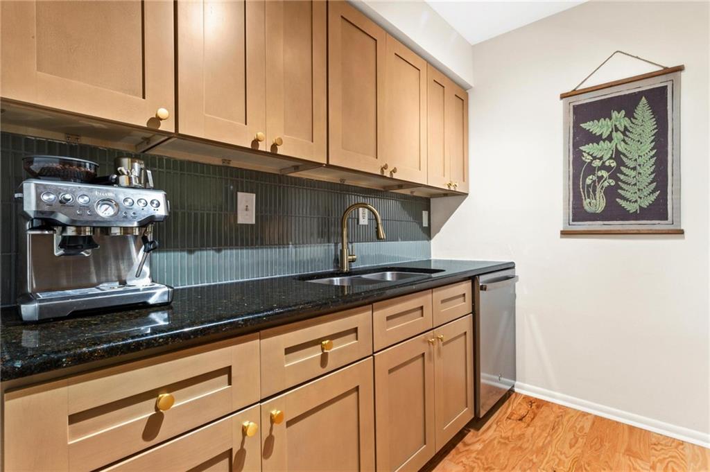 1150 Collier Road Northwest, Unit A10 Atlanta, GA 30318 - Photo 12 of 34 a kitchen with stainless steel appliances granite countertop a sink a stove and cabinets