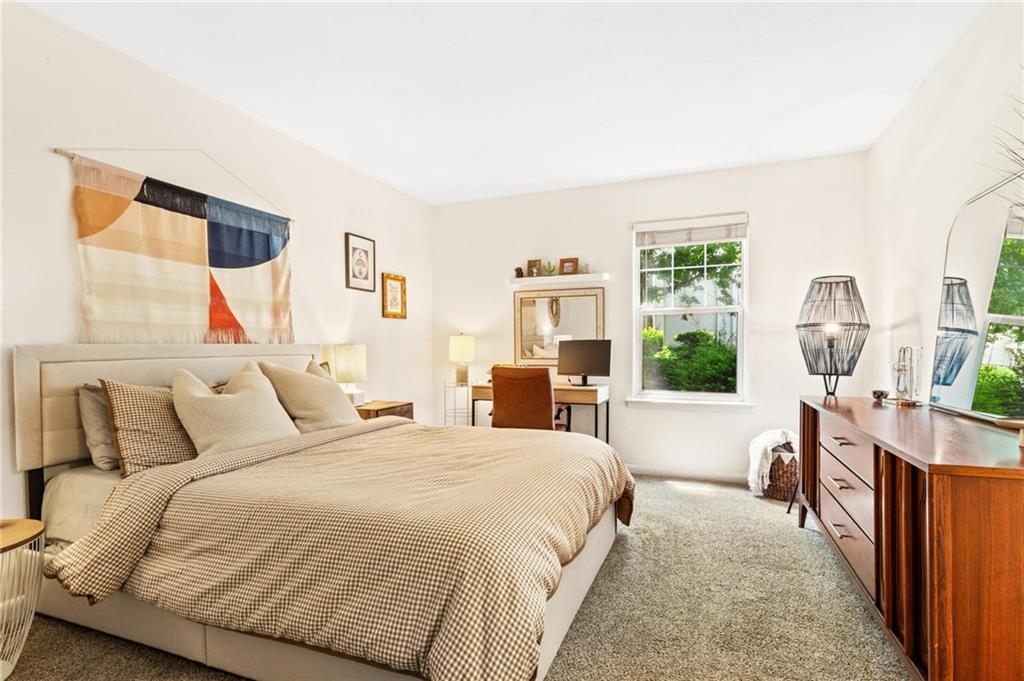 1150 Collier Road Northwest, Unit A10 Atlanta, GA 30318 - Photo 14 of 34 a bedroom with a bed a table and chair