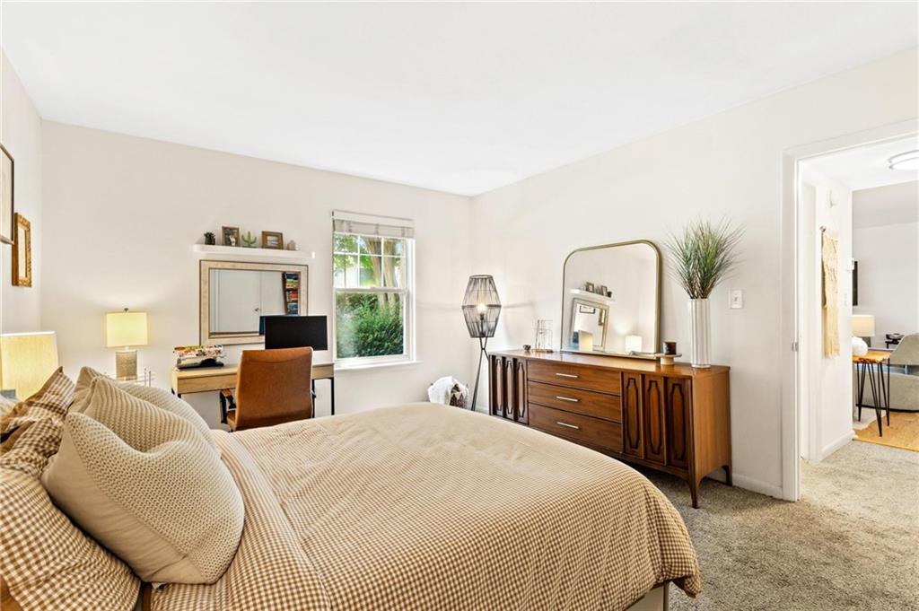 1150 Collier Road Northwest, Unit A10 Atlanta, GA 30318 - Photo 15 of 34 a bedroom with furniture a bed and a dresser