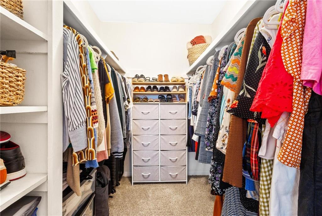 1150 Collier Road Northwest, Unit A10 Atlanta, GA 30318 - Photo 18 of 34 a view of walk in closet with clothes and shoes