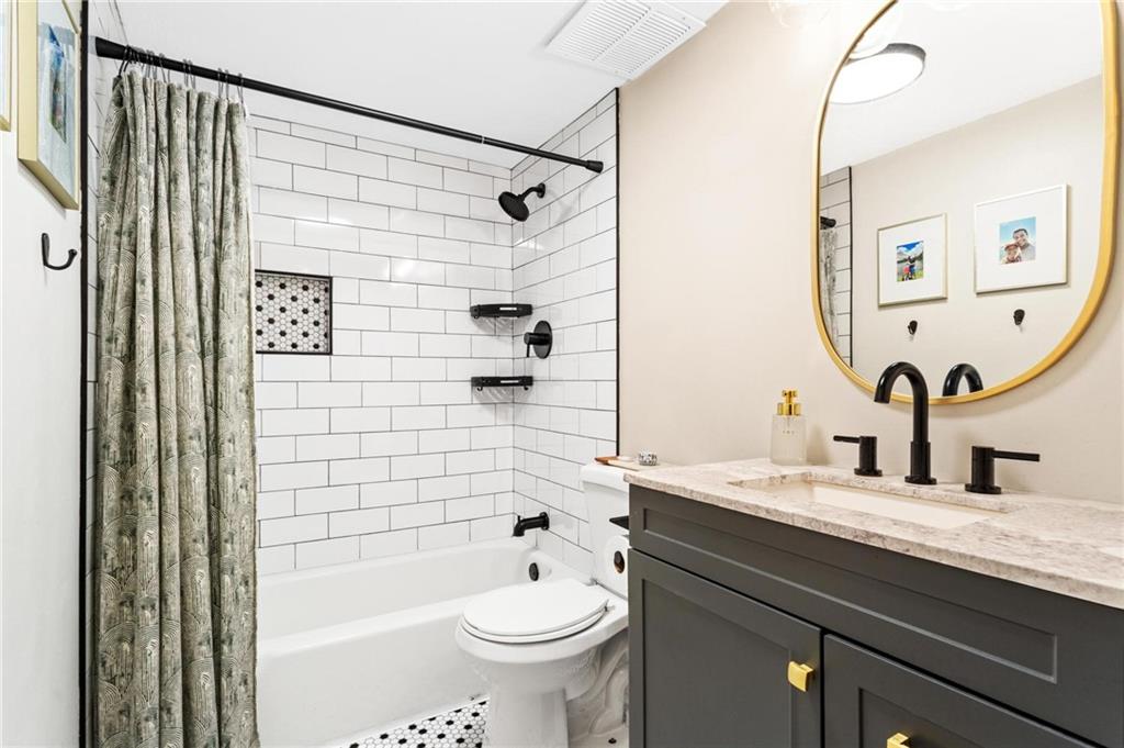 1150 Collier Road Northwest, Unit A10 Atlanta, GA 30318 - Photo 21 of 34 a bathroom with a sink a toilet and shower