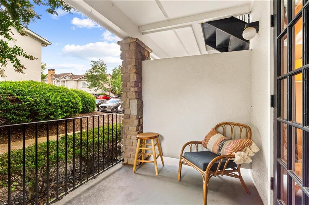 1150 Collier Road Northwest, Unit A10 Atlanta, GA 30318 - Photo 23 of 34 a view of balcony with two chairs and a book shelf