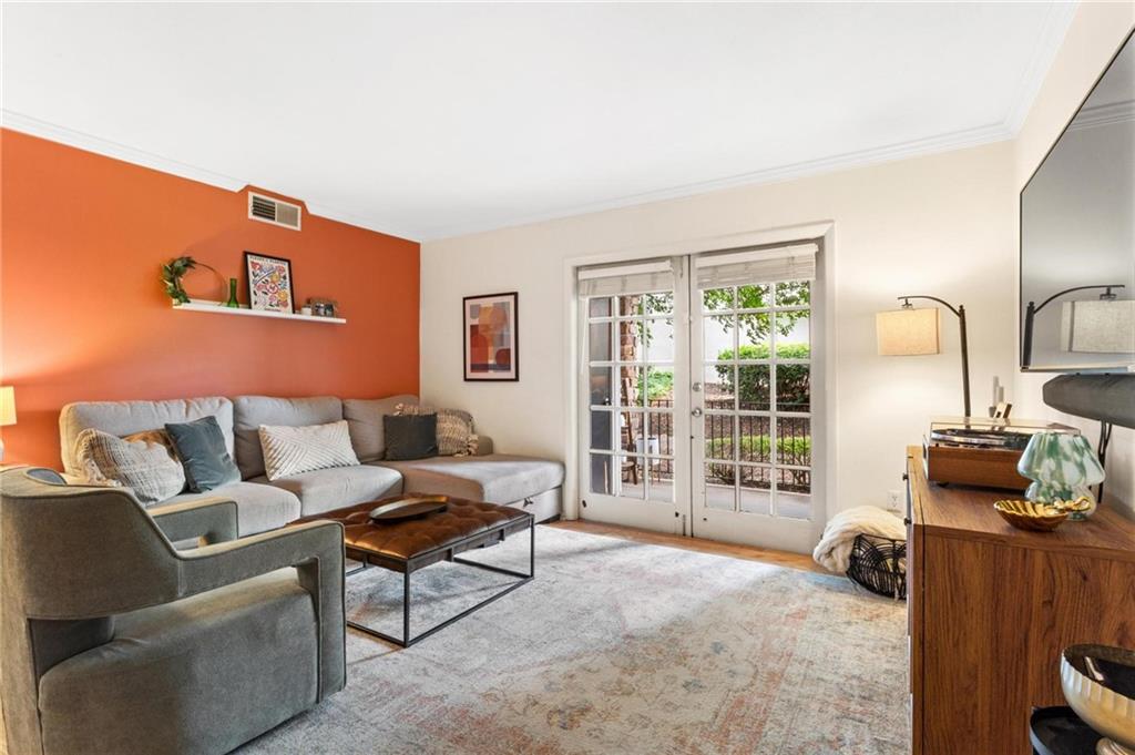 1150 Collier Road Northwest, Unit A10 Atlanta, GA 30318 - Photo 3 of 34 a living room with furniture and a flat screen tv