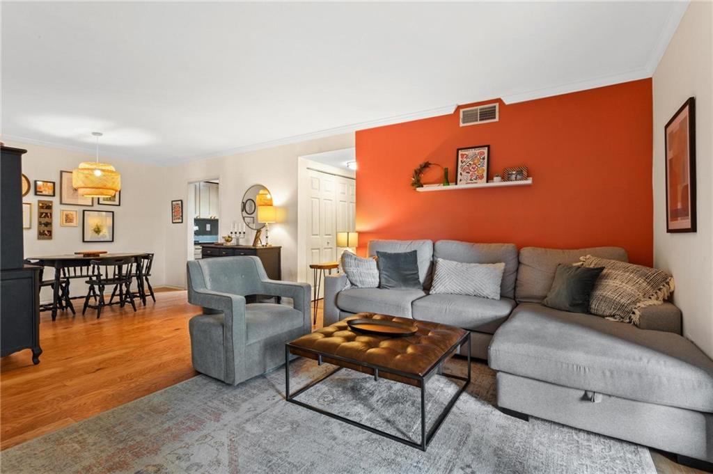 1150 Collier Road Northwest, Unit A10 Atlanta, GA 30318 - Photo 5 of 34 a living room with furniture a dining table and a potted plant