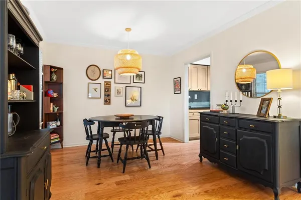 a view of a dining room with furniture and a chandelier
