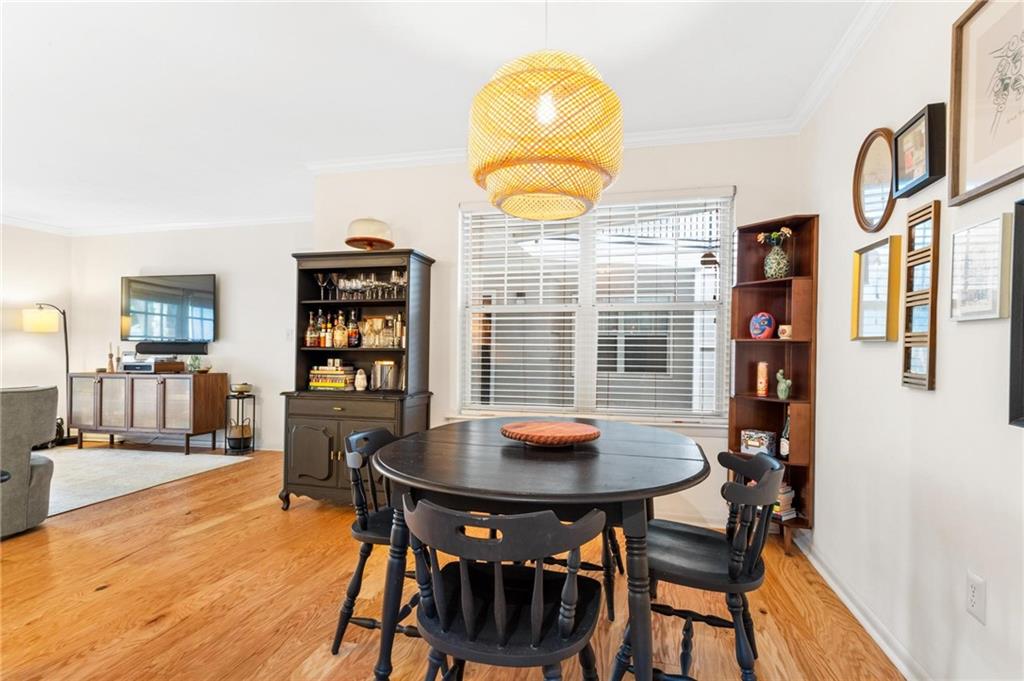 1150 Collier Road Northwest, Unit A10 Atlanta, GA 30318 - Photo 10 of 34 a view of a dining room with furniture and wooden floor