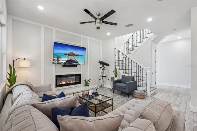 a living room with furniture and kitchen view