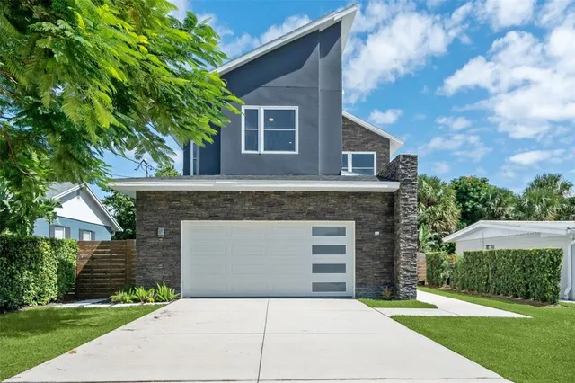 a front view of a house with a garden