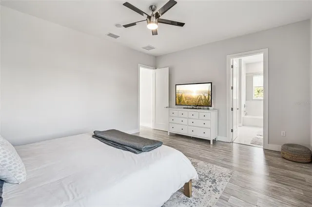 a bedroom with a bed and a flat screen tv