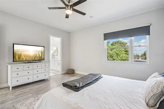 a bathroom with a sink double vanity granite tub and a mirror