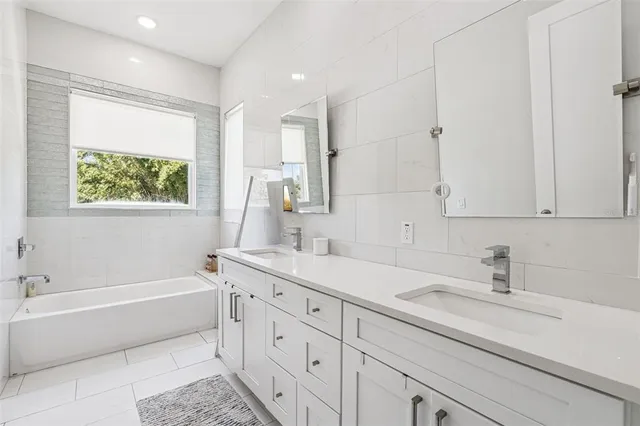 a hallway with sink and mirror