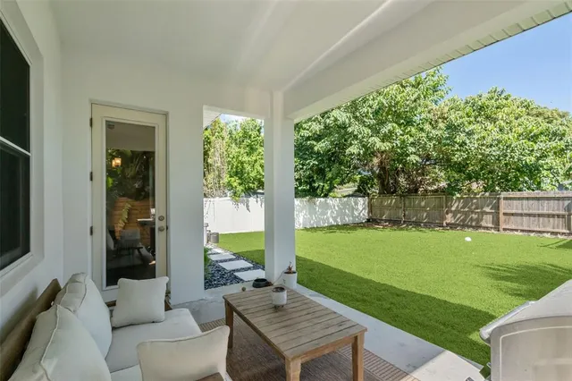 a view of a house with backyard and a tree