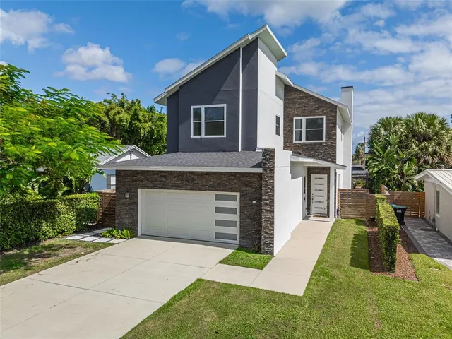 an aerial view of a house with a swimming pool