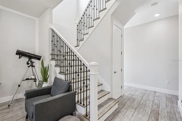 a kitchen with stainless steel appliances granite countertop a white cabinets and a refrigerator