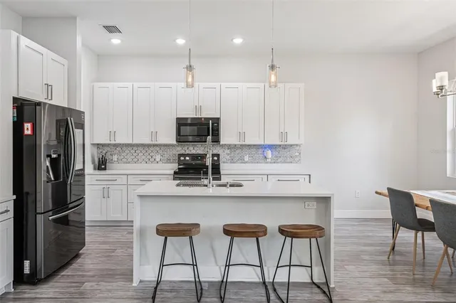 a kitchen with stainless steel appliances a white cabinets and a sink
