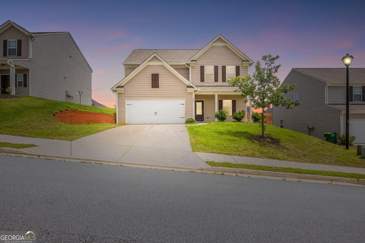 a front view of a house with a yard and garage