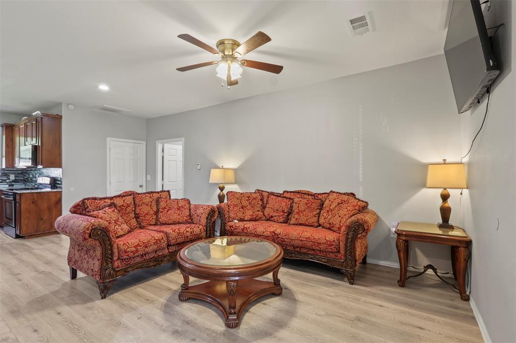 1556 John Wayne Road Kaufman, TX 75142 - Photo 4 of 33 a living room with furniture and a flat screen tv
