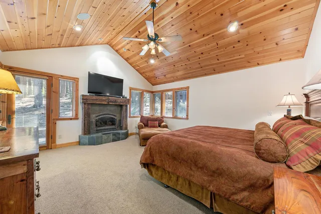 a spacious bedroom with a bed and a flat screen tv