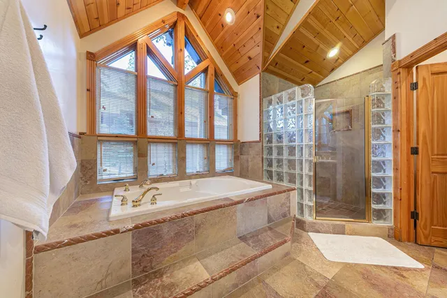 a spacious bathroom with a granite countertop sink and a bathtub
