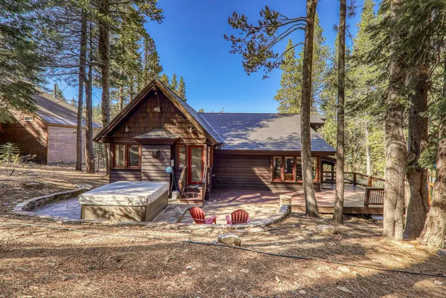 a view of a house with snow on the side of the road
