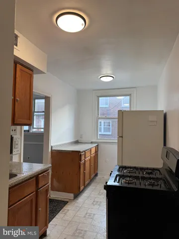 a kitchen with cabinets and window