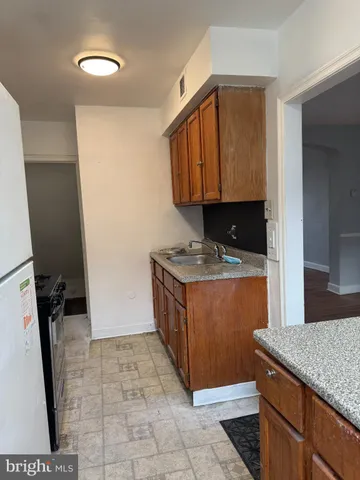 a kitchen with granite countertop a sink a stove and a microwave