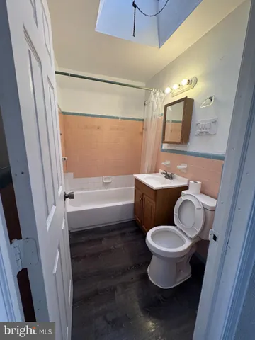 a bathroom with a toilet a sink and a mirror