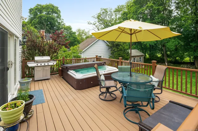 a view of deck with table and chairs under an umbrella