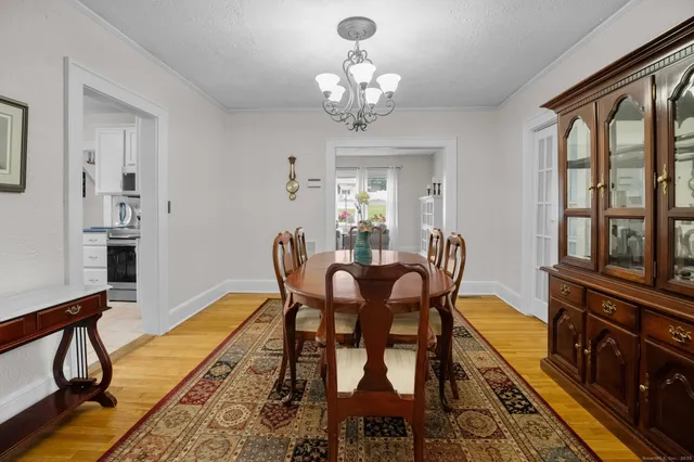 a view of a dining room with furniture and a chandelier
