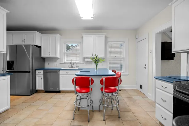 a kitchen with stainless steel appliances a refrigerator sink and stove