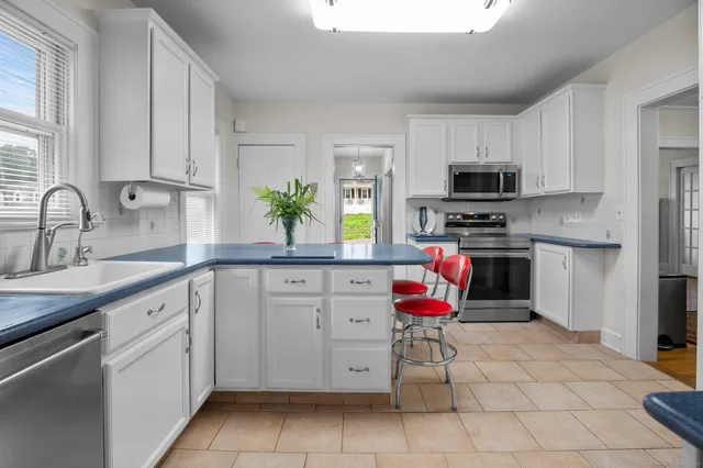 a kitchen with appliances cabinets and a sink