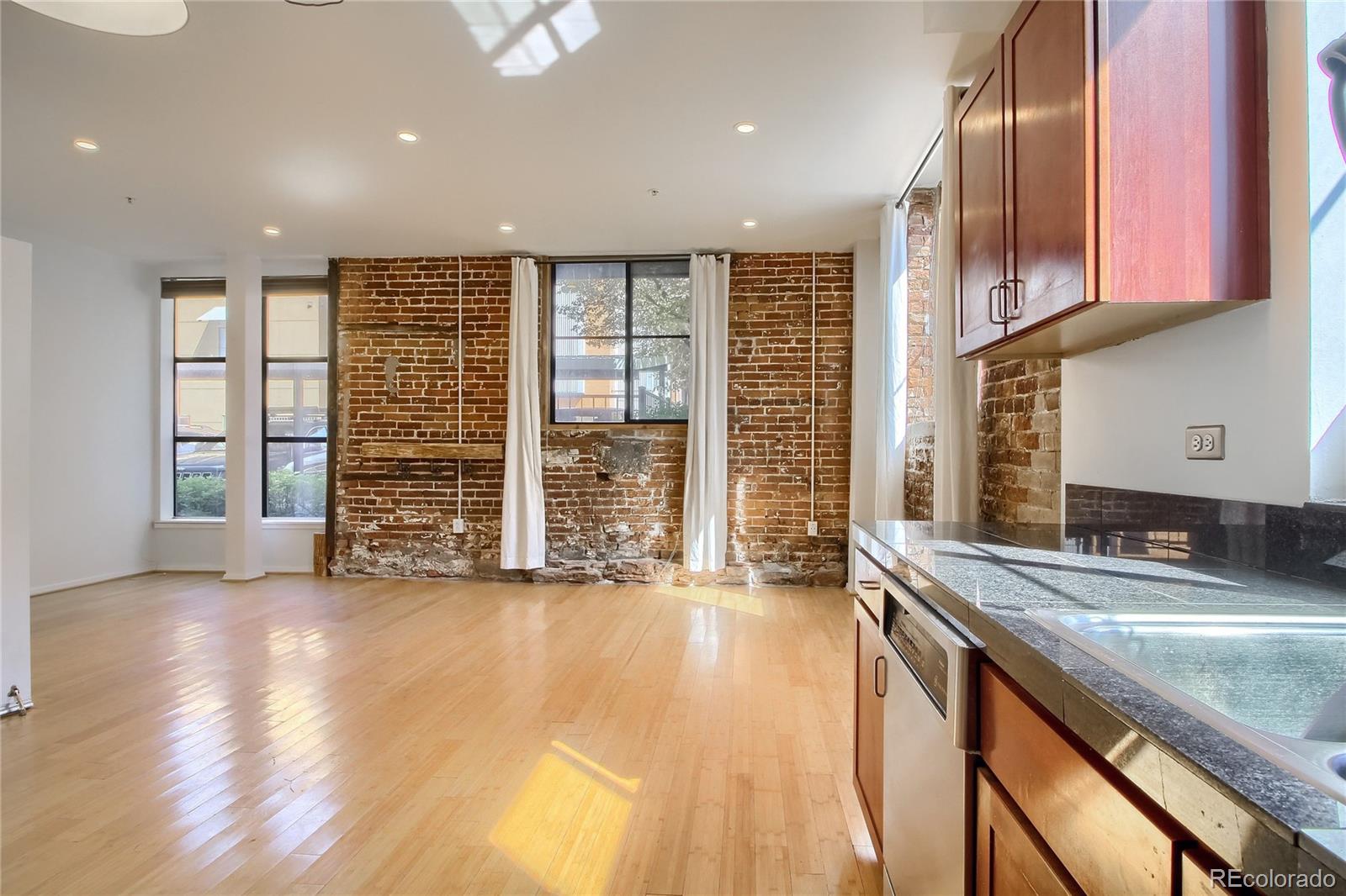 3225 Blake Street, Unit 2 Denver, CO 80205 - Photo 11 of 31 an empty room with wooden floor and cabinet with wooden floor