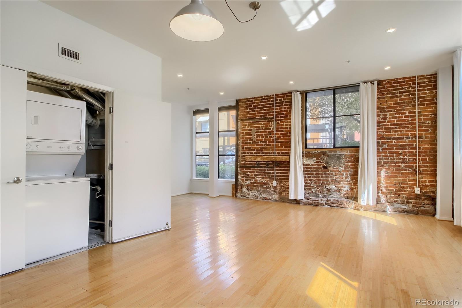3225 Blake Street, Unit 2 Denver, CO 80205 - Photo 18 of 31 an empty room with wooden floor and windows