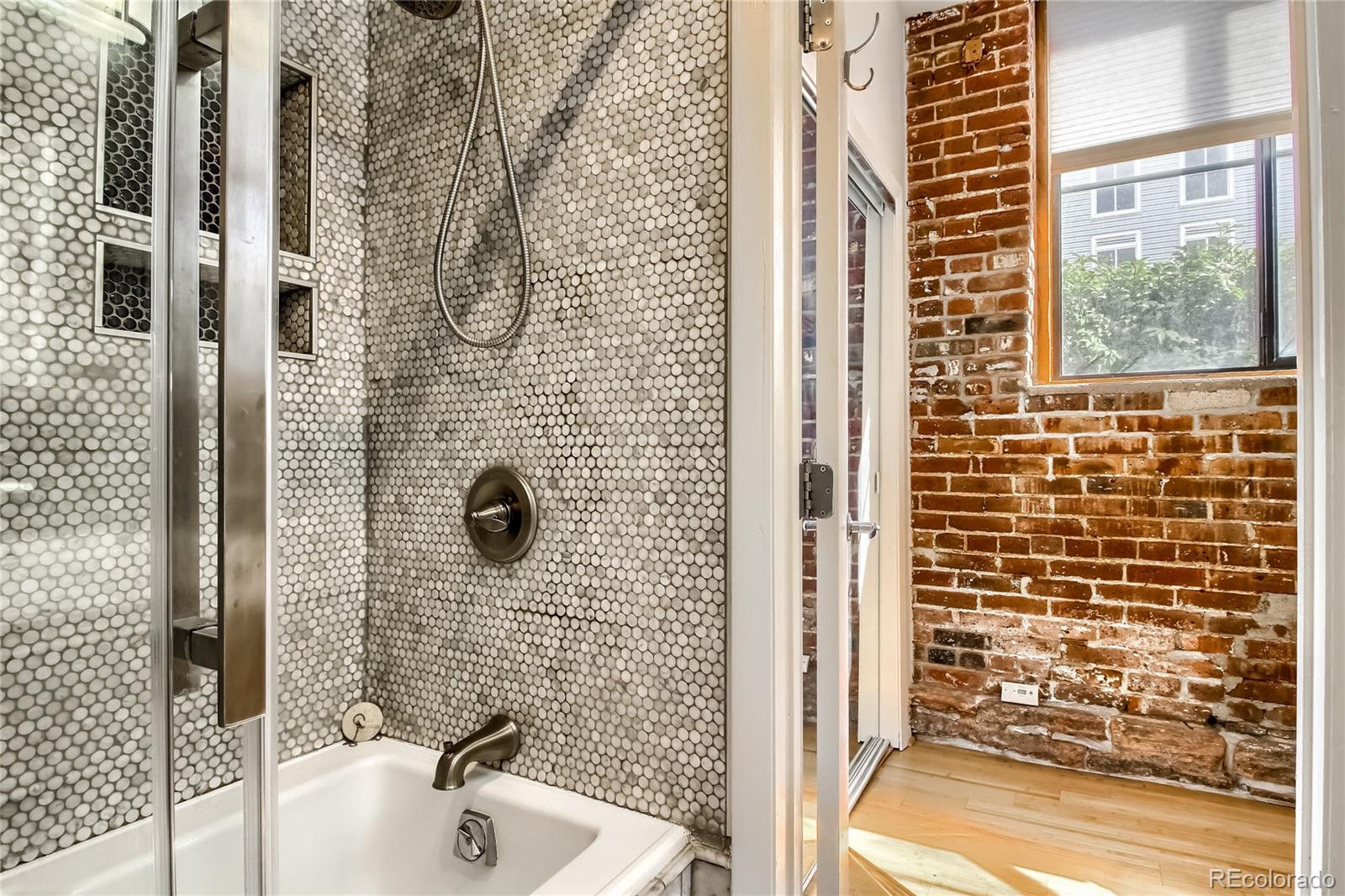 3225 Blake Street, Unit 2 Denver, CO 80205 - Photo 27 of 31 a bathroom with a sink a window and shower