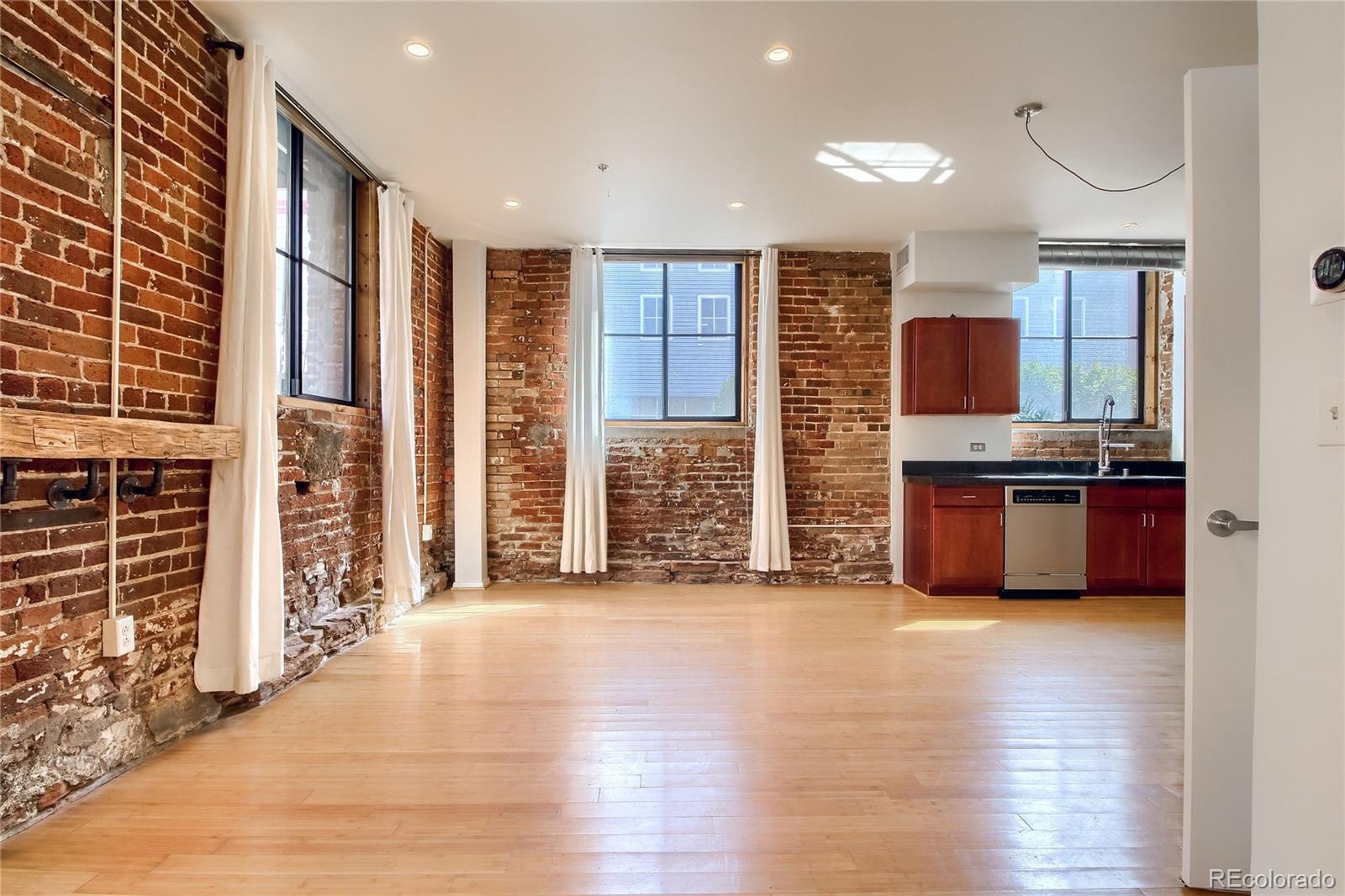 3225 Blake Street, Unit 2 Denver, CO 80205 - Photo 5 of 31 a kitchen with stainless steel appliances a refrigerator and a stove top oven