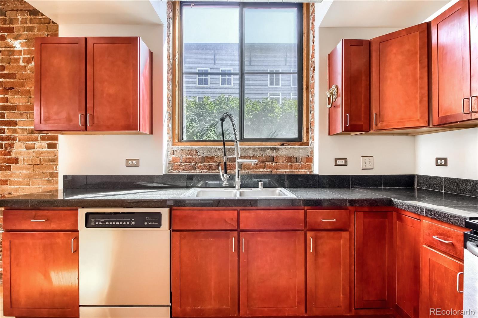 3225 Blake Street, Unit 2 Denver, CO 80205 - Photo 8 of 31 a kitchen with stainless steel appliances granite countertop a sink and a cabinets