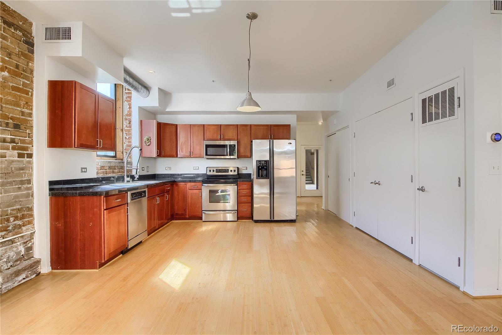 3225 Blake Street, Unit 2 Denver, CO 80205 - Photo 10 of 31 a large kitchen with stainless steel appliances granite countertop a stove a sink dishwasher and a refrigerator