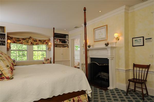 113 Cliff Road Wellesley, MA 02481 - Photo 15 of 25 a bed room with a bed and a fireplace