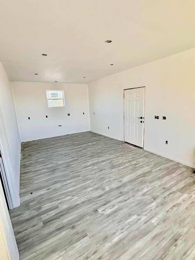14714 Eiler Road Del Valle, TX 78617 - Photo 4 of 7 a view of a room with wooden floor