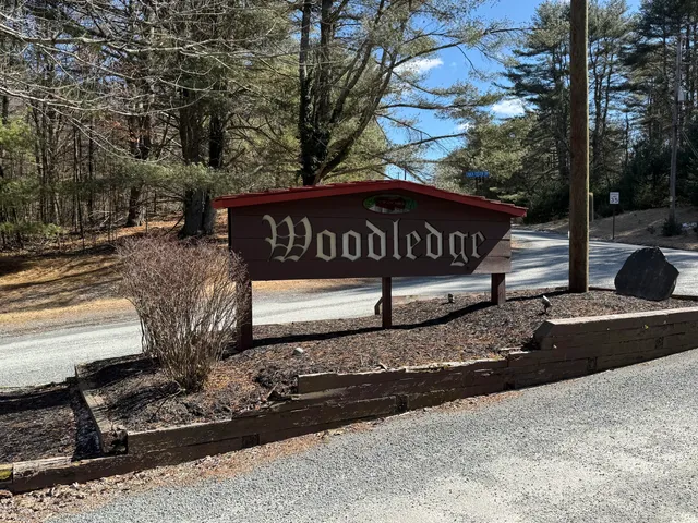 a view of a street with benches sitting next to a road
