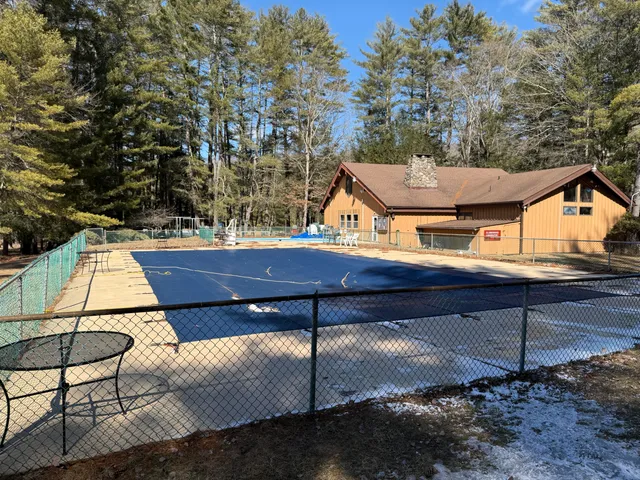 a view of a patio with table and chairs with wooden floor and fence