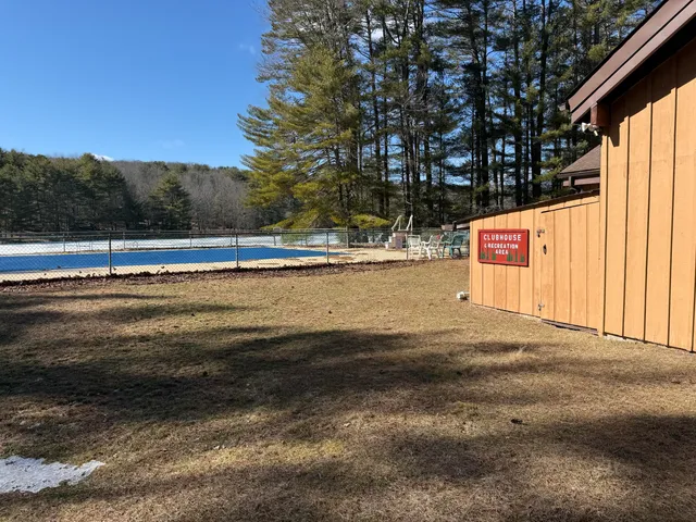 a view of swimming pool with trees in the background
