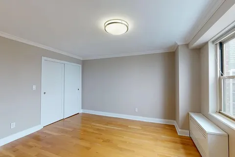 a view of room with window and wooden floor
